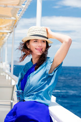 Wall Mural - photo of beautiful young woman on the boat in front of sea background in Greece