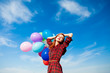 © Masson - beautiful young woman with colorful balloons on the wonderful sky background