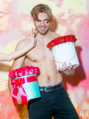 Wall Mural - bearded muscular man with sexy body holds red rose box