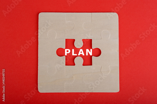 Fotografie, Tablou Jigsaw Puzzle Pieces with word "Plan" on red background