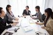 © amanaimages - Business people talking in boardroom meeting