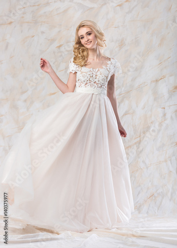 A Gorgeous Smiling Blonde Bride With Beautiful Curly Hair In A