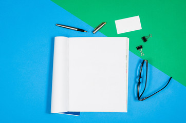 Poster - Mock-up magazine or catalog on colorful table. White page or notepad on modern background. Blank copy space for mockups or simulations.