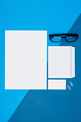 Poster - Mock-up magazine or catalog on colorful table. White page or notepad on modern background. Blank copy space for mockups or simulations.