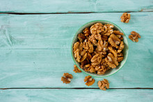 Walnuts In A Bowl On Turquoise Surface