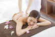 © amanaimages - Masseuse giving a back massage to a woman in a spa