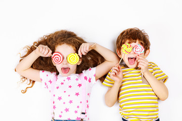 Funny children hold candy lollipop. Healthy lifestyle concept.