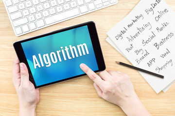 Aufkleber - Hand using tablet with Algorithm word on screen with list of digital marketing features on paper on work table,Online business concept
