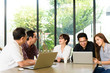 © livertoon - Asian Team group freelancer are brainstorming and meeting at coffee shop cafe. Feeling funny and happy.