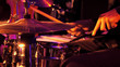 © kirill4mula - Drummer plays on drum set and cymbal with drumsticks on the stage. Jazz or rock concert performance entertainment. Close up shot with soft selective focus.