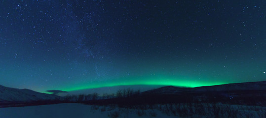 panorama with milky way and northen lights aurora.