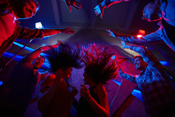 Wall Mural - Ecstatic teens enjoying disco in night club