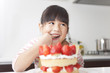 © amanaimages - Girl eating strawberry cake