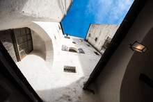 White Walls And Windows Of Ancient Building And Blue Sky