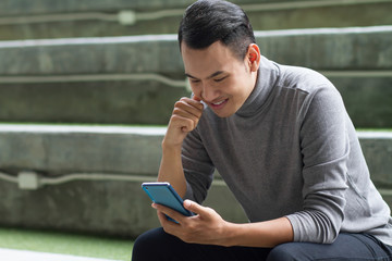 happy, smiling man with smart phone