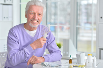 elderly man doing inhalation