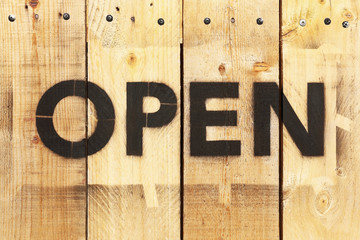 Poster - open word by black spray on wood board