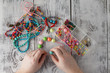 © Andrey Cherkasov - man hand making earrings of polymer clay. Hobby, handicraft background