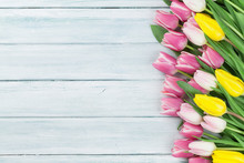 Colorful Tulips Over Wooden Background