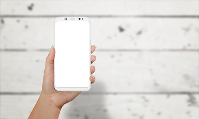 Aufkleber - Woman showing smart phone with round edges. Moder phone with isolated screen for mockup. White wooden desk in background.