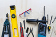 © ss_comm - Bunch of Working Tools over Wooden Background