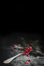 Fresh And Juicy Pomegranate Seends On A Dark Background