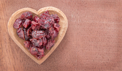 Wall Mural - Dried cranberries on wooden background