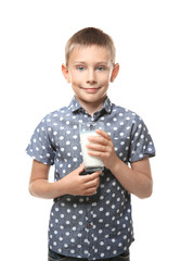 Poster - Smiling little boy holding glass of milk isolated on white