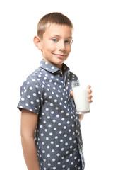 Poster - Smiling little boy holding glass of milk isolated on white