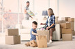 © Africa Studio - Happy family packing boxes in room. Moving concept