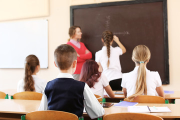 Wall Mural - Pupils listening teacher in classroom