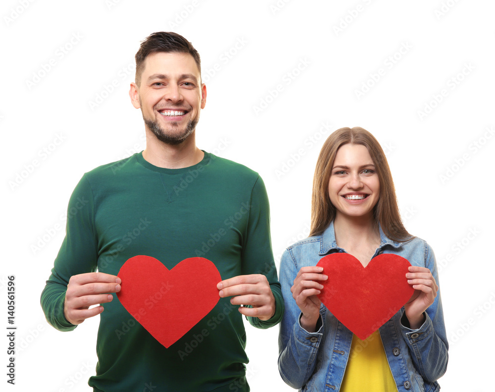 Happy young couple with red hearts on white background