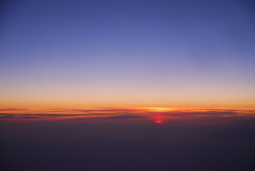 Wall Mural - sunrise from horizon seen from air plane in the sky
