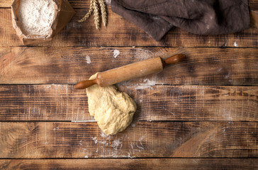 Poster - Fresh dough with rolling pin and flour on wooden table