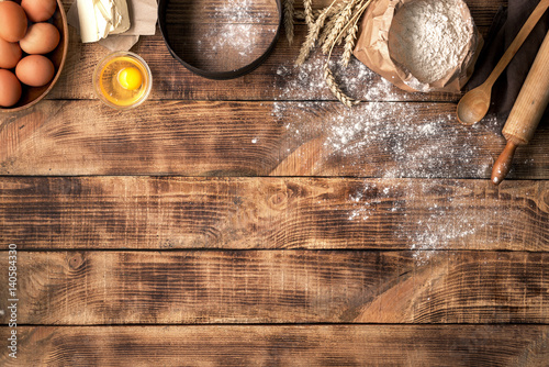 Fotografía Flour with ingredients for bakery products on wooden background