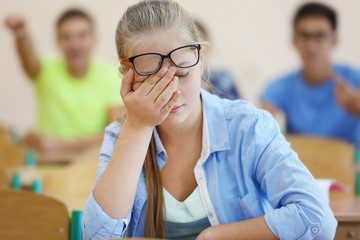 Wall Mural - Student with group of classmates in classroom