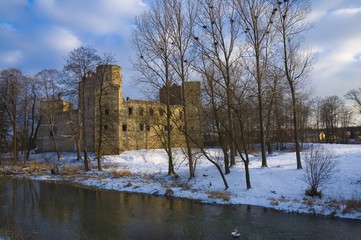 Wall Mural - Well-preserved ruin of Gothic and Renaissance styles castle of the Archbishop of Gniezno by the Drzewiczka River in Drzewica in warm light of sunset, Poland