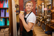 © MDBPIXS - Portrait of male salesperson holding disposable coffee cup in store