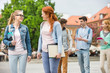 © MDBPIXS - Young college friends walking on street
