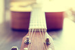 Classic acoustic guitar at weird and unusual perspective closeup. Coloring photo with soft focus in instagram style. Musical instruments shop or learning school concept