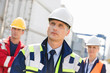 © MDBPIXS - Team of confident workers in shipping yard