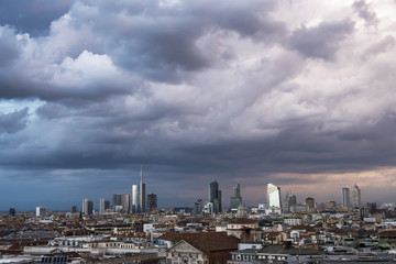 Wall Mural - Milan panoramic skyline with storm clouds and the new modern skyscrapers in Porta Nuova business district in Milan, Italy. 