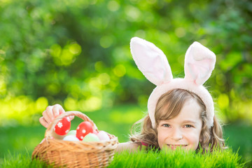 Wall Mural - Easter bunny and eggs on green grass