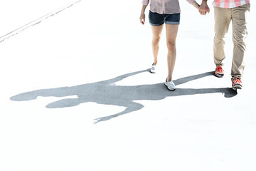 Wall Mural - Low section of couple walking on street