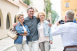 © MDBPIXS - Rear view of man photographing friends in city