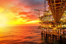 Offshore Oil And Rig Platform In Sunset Or Sunrise Time. Construction Of Production Process In The Sea. Power Energy Of The World.