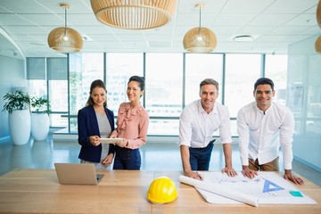 Smiling architects standing together in office