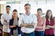 © WavebreakMediaMicro - Business executives with arms crossed standing in office