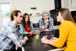 © W PRODUCTION - group of young cool attractive people talking and drinking coffee at home together in the kitchen