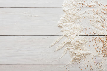 Baking concept on wood background, sprinkled flour with copy space